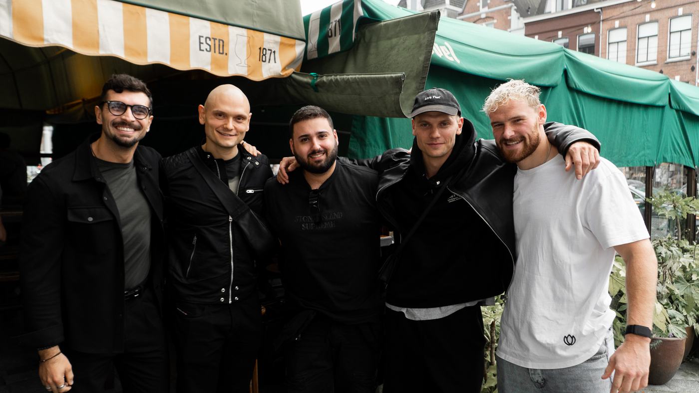 Five guests posing outside Café Kuijper