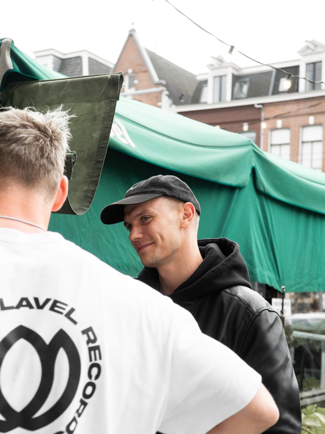 A guest in a Relavel Records shirt outside the café