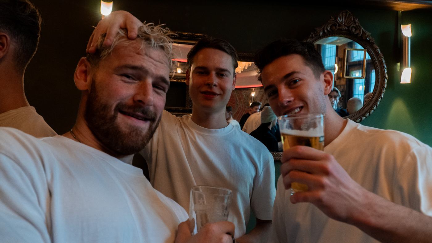 Three guests raising their glasses